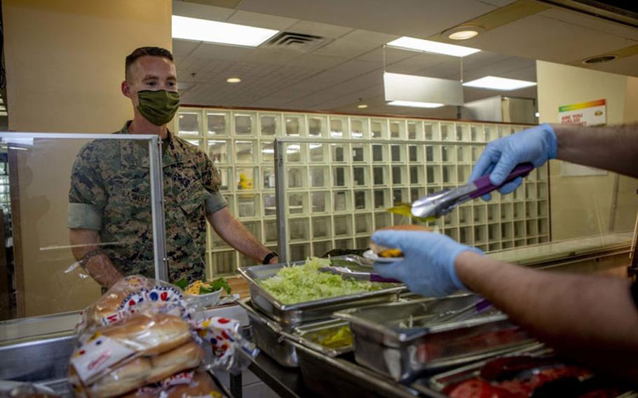 Mess hall patrons test a new menu item, May 13, 2020 at Marine Corps Air Station Futenma, Okinawa, Japan. In an effort to be more inclusive of Marines with different lifestyles, MCAS Futenma’s mess hall was the first military dining facility on Okinawa to introduce a plant-based burger to it’s menu. (U.S. Marine Corps photo by Cpl. Christopher A. Madero)