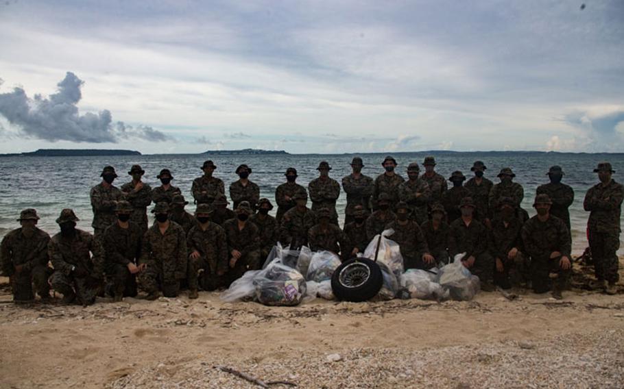 Marines with Combined Anti-Armor Team 1 (CAAT), Battalion Landing Team, 2nd Battalion, 4th Marines, 31st Marine Expeditionary Unit (MEU), pose for a group photo following a beach cleanup at Kin Blue, Okinawa, Japan, July 25, 2020. (U.S. Marine Corps photo by Lance Cpl. Kolby Leger)