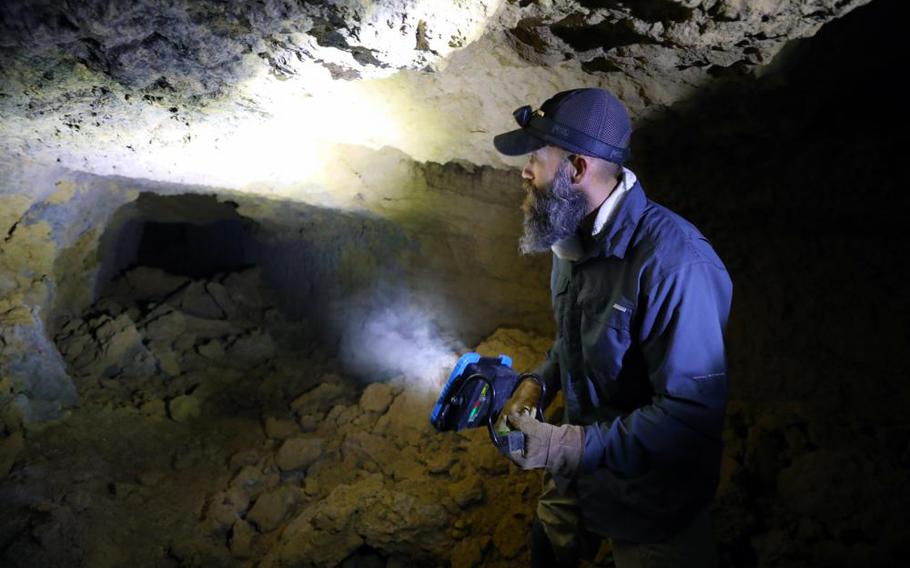 Matthew Small, an Unexploded Ordinance Quality Assurance Representative with the U.S. Army Corps of Engineers – Japan Engineer District, examines the remains of a World War II-era Japanese tunnel on the island of Okinawa, Japan. The tunnel is thought to hold the body of Pfc. John Quinn, a Marine who went missing during the final days of the Battle of Okinawa in 1945.