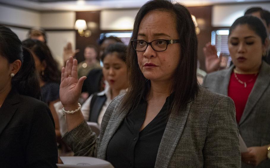 Twenty three service members and active duty spouses, from 16 different countries, gathered at Camp Foster, Feb. 27, 2020, for a naturalization ceremony to become an admitted citizen of the United States of America. The ceremony room was filled with family and friends to observe the final part of the overseas naturalization process.