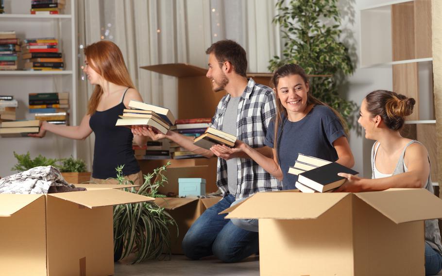 teenagers moving boxes