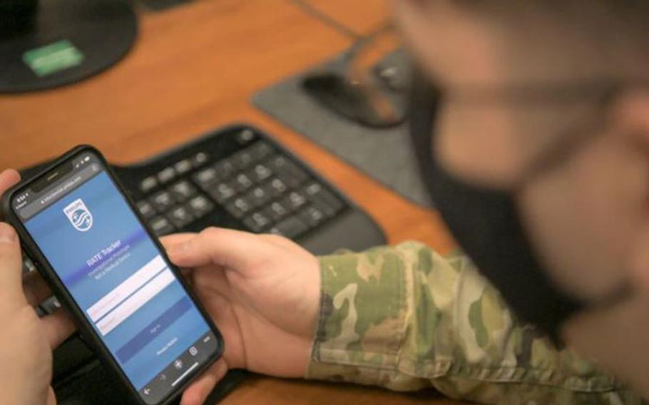 An Airmen from the 18th Component Maintenance Squadron prepares to login to the Rapid Analysis of Threat Exposure app at Kadena Air Base, Japan, April 29, 2021. The RATE app is used to securely monitor the user’s health biometrics such as their sleep data and respiratory rate. (U.S. Air Force photo by Senior Airman Demond Mcghee)