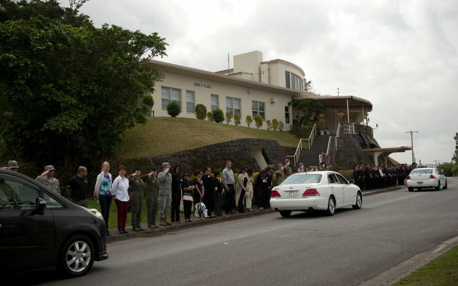 Team Kadena members and friends of Sadamu “Jack” Oshiro stand for a memorial procession convoy outside of Jack’s Place at Kadena Air Base, Japan.