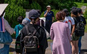 Hideaki Sakihama, 18th Wing Public Affairs community engagement specialist, explains the importance of the former hospital cave on Kadena Air Base.