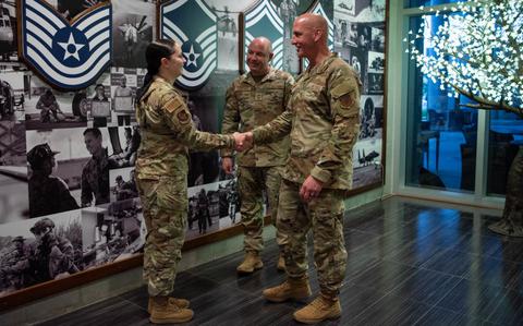 Photo Of Chief Master Sergeant of the Air Force David Flosi coins U.S. Air Force Senior Airman Lillie Jimenez Guzman, 353rd Special Operations Wing imagery analyst, during his visit to Kadena Air Base, Japan, April 6, 2024.