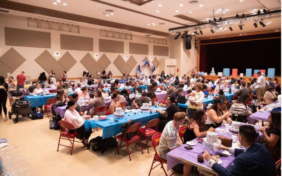 Service members and their families participate in games over lunch during a military baby shower on Camp Foster, Okinawa, Japan.