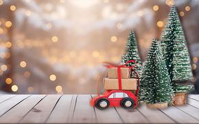 minitures of cars with packages and christmas trees on the table.