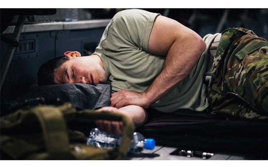 A U.S. Air Force Airman sleeps inside a C-17 Globemaster III during a flight over an undisclosed location in support of Operation Freedom Sentinel, Jan. 22, 2018. (U.S. Air Force photo by Staff Sgt. Jordan Castelan)