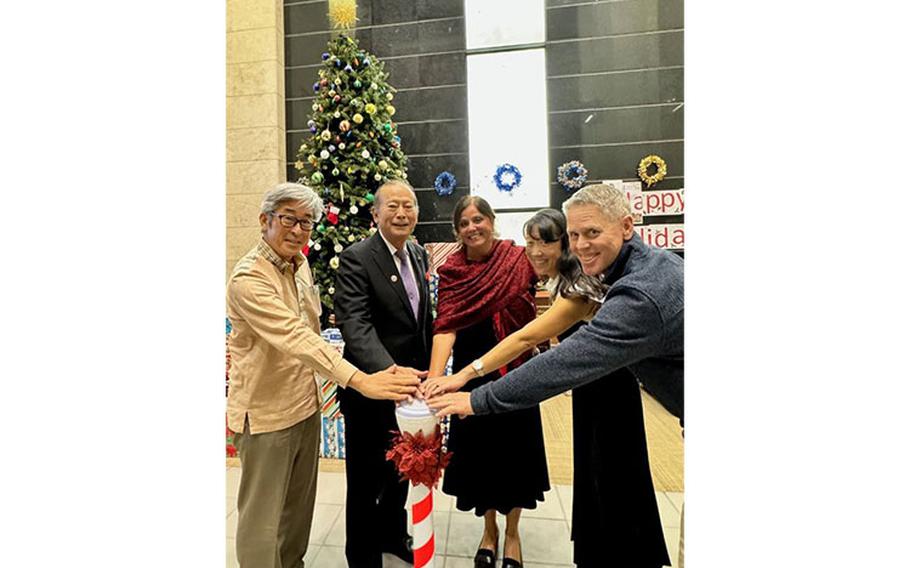 USNHO Triad and distinguished visitors press the button to light the tree. Photo by Isaac Savitz