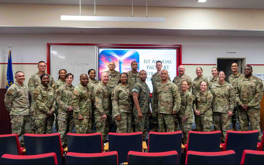 U.S. Air Force Airmen and U.S. Marine Corps Sgt. Maj. Terrell Ford, Noncommissioned Officer Academy Okinawa director of staff, pose for a photo during the first annual Pacific Air Forces Strategic Development event at Kadena Air Base.