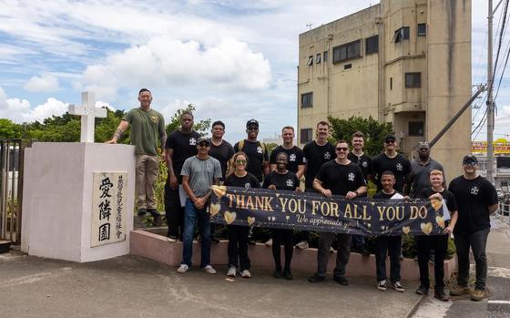 U.S. Marines and Sailors with Marine Aircraft Group 36, 1st Marine Aircraft Wing pose for a photo at the Ai Rin Children’s Home in Yonabaru.