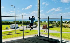 A patron completes an afternoon workout on the outdoor exercise pad at Torii Fitness Center, Torii Station, Japan.