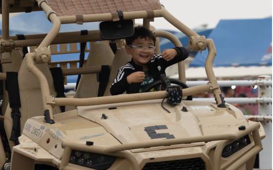 A child sits in a Utility Task Vehicle on display during the Camp Schwab Festival on Camp Schwab, Okinawa, Japan, March 30, 2024.