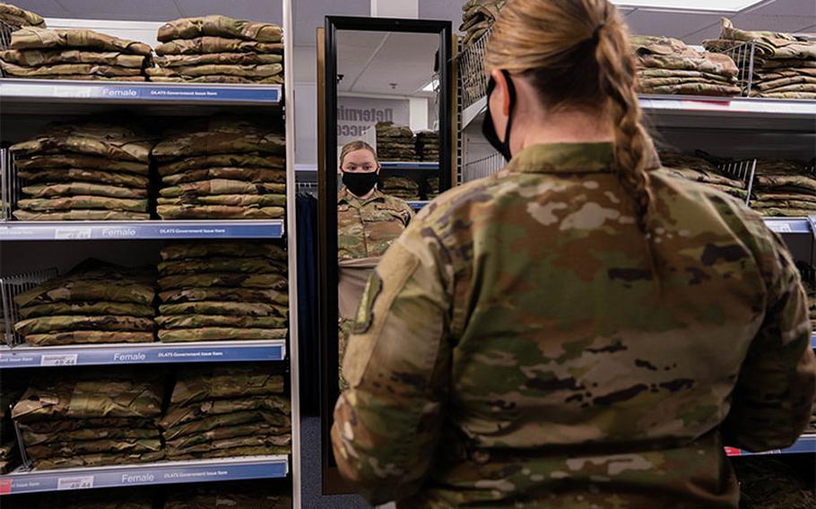 Senior Airman Quynn Santjer, unit deployment manager for the 94th Fighter Squadron, looks through the new abundance of maternity options at Military Clothing Sales at Joint Base Langley-Eustis, Va., Dec. 2, 2021. Santjer was happy to know that her co-worker, who is newly pregnant, will not have to wait for uniforms to be shipped to her like she did. (U.S. Air Force photo by Staff Sgt. Jaylen Molden)