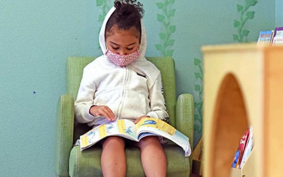 Karina Melendez, 5, reads a book in the reading corner of a Fort Bliss Child Development Center, Aug. 10, 2020. Now, the Pfizer-BioNTech vaccine for 5 through11 year olds has been authorized and is being offered to protect this age group against COVID-19.