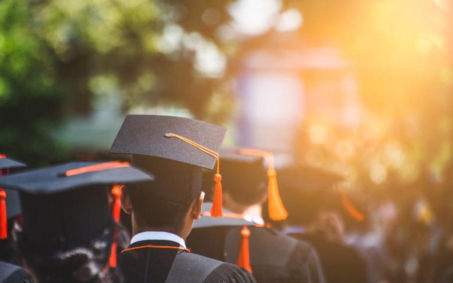 Rear view of Graduates join the graduation ceremony. ()