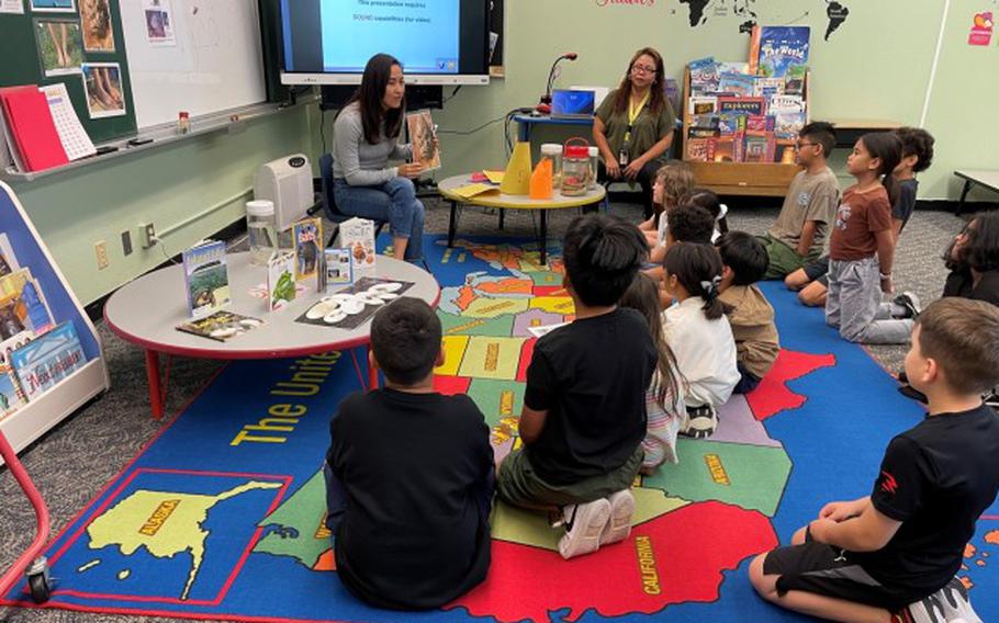 U.S. Army Garrison Okinawa’s command safety program administrator, Akiko Fukai, right, and Christine McNeace, left, Army school liaison office, educate Amelia Earhart Intermediate School students on marine safety during a Career Day at Kadena Air Base, Okinawa, Japan, May 2, 2024.