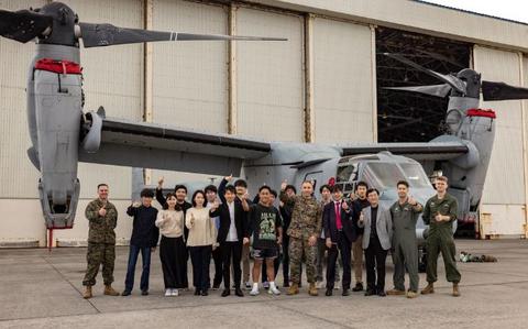 Photo Of Japanese college students, senior leaders of Marine Corps Air Station Futenma, and U.S. Marines with 1st Marine Aircraft Wing, pose for a group photo during the University of Tokyo’s visit to MCAS Futenma, Okinawa, Japan, Feb. 28, 2024.