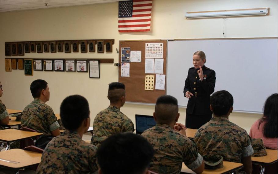 U.S. Marine Corps Maj. Shannon Gross, right, commanding officer of Recruiting Station San Diego, 12th Marine Corps District, speaks to cadets from the Okkodo High School Marine Corps Junior Officers’ Training Corps program during a scholarship presentation held at the school in Dededo, Guam, Feb. 29, 2024.