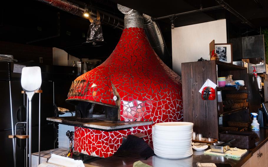 a big brick pizza oven colored in vibrant red