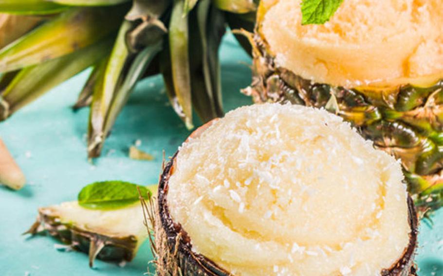 Sorbet in coconut shell with pineapple in background