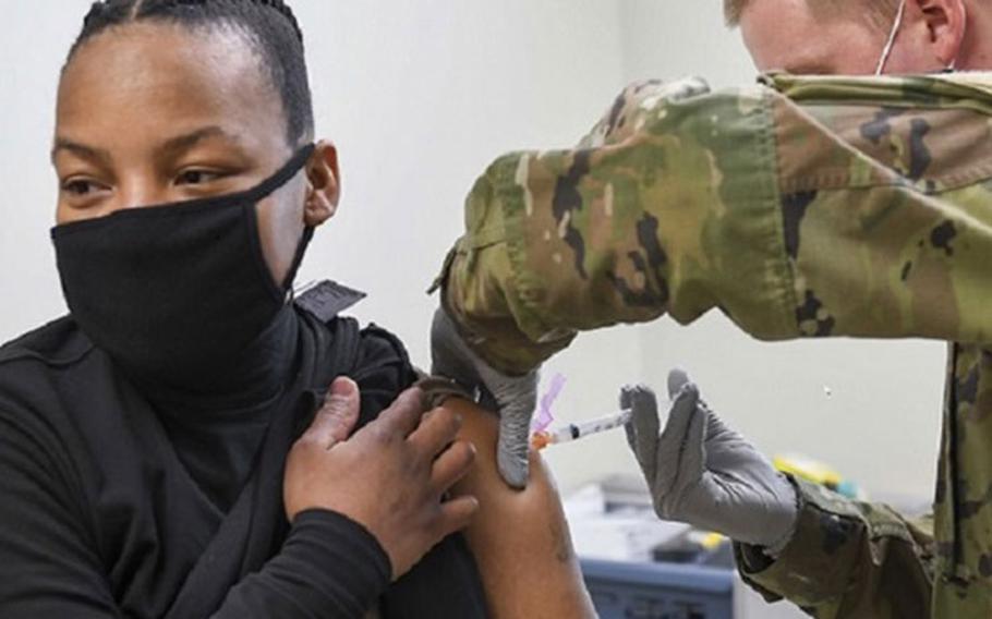 Army Spc. William Hunter, right, administers the COVID-19 vaccine to Navy Chief Damage Controlman Solita Livingston at Navy Branch Health Clinic Chinhae, Republic of Korea, Jan. 8. Soldiers assigned to the 549th Medical Hospital Center, 65th Medical Brigade volunteered to administer the COVID-19 vaccine to sailors who were identified as frontline personnel by their commands (Photo by: Navy Mass Communications Specialist 2nd Class Michael Chen).