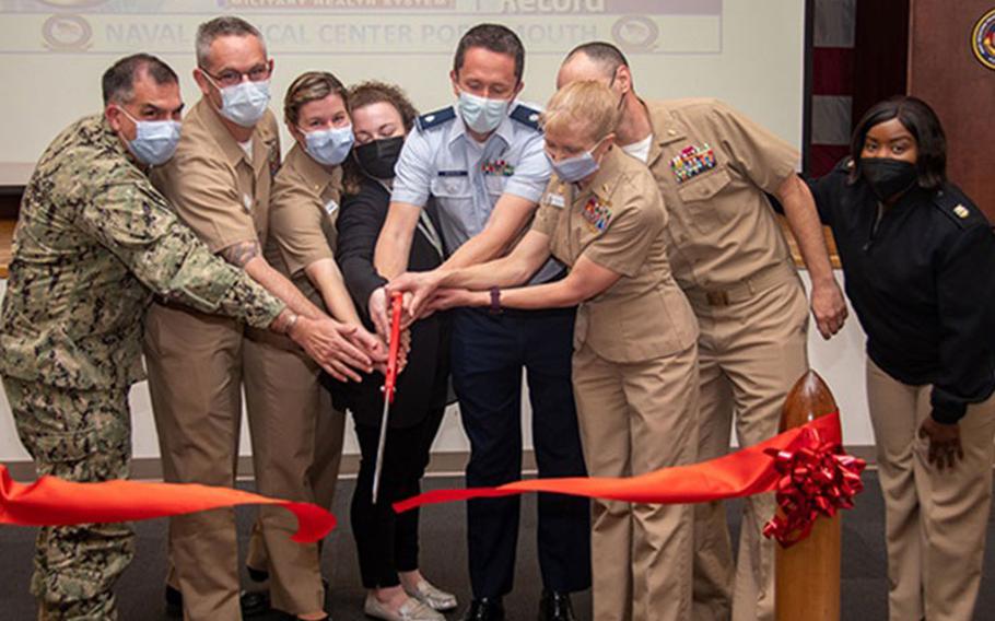 The director of the Tidewater Market, NMCP leadership and the MHS GENESIS team cut a ribbon officially marking the launch of the new Electronic Health Record System, MHS GENESIS, at NMCP and its clinics. (Credit: U.S. Navy MC2 Dylan Kinee, NMC Portsmouth)