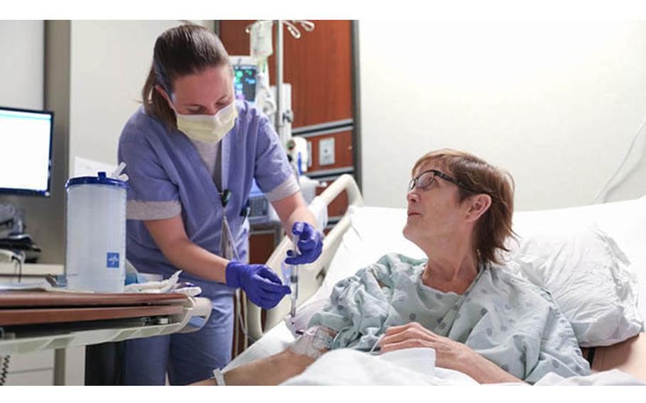 Air Force 1st Lt. Torri Easley, a clinical nurse, provides care to Vicki Beeler, a patient at INTEGRIS Baptist Medical Center in Oklahoma City, Oklahoma, Feb. 10, 2022. The U.S. Air Force medical team, working side-by-side with civilian medical professionals, has been deployed in support of continued Department of Defense COVID-19 response operations.