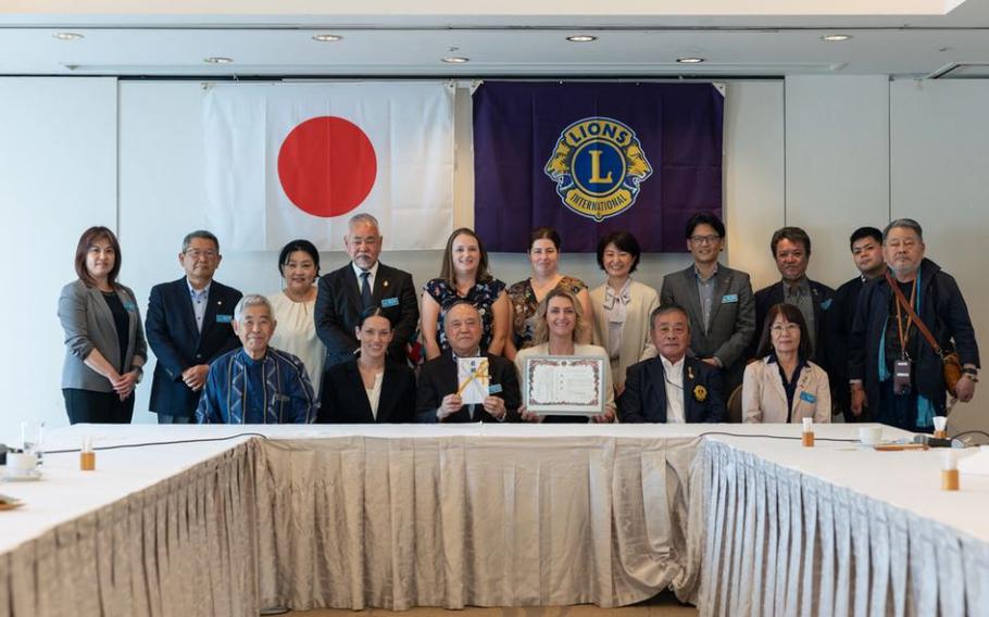 Marine Thrift Shop Okinawa staff members and representatives of Lions Clubs International, Okinawa, pose for a group photo after an official donation and the exchange of gifts at the Okinawa Harborview Hotel in Naha City, Okinawa, Japan, Feb. 22, 2024.