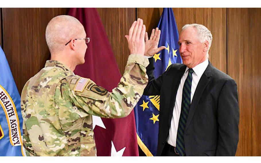Defense Health Agency (DHA) Director Lt. Gen. (Dr.) Ron Place, left, swears in Dr. Michael Malanoski as new DHA Deputy Director, in Falls Church, Virginia, May 9, 2022.