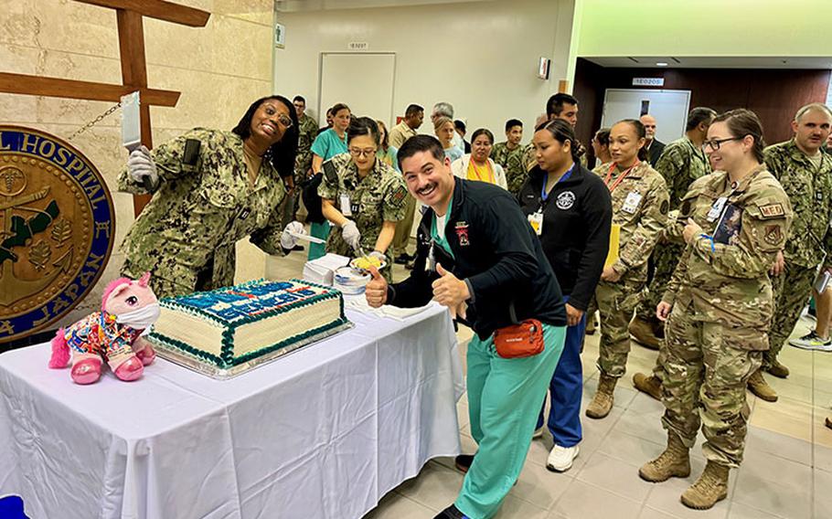 Sailors from USNMRTC Okinawa enjoy cake the morning of the MHS GENESIS launch. (photo: Isaac Savitz)