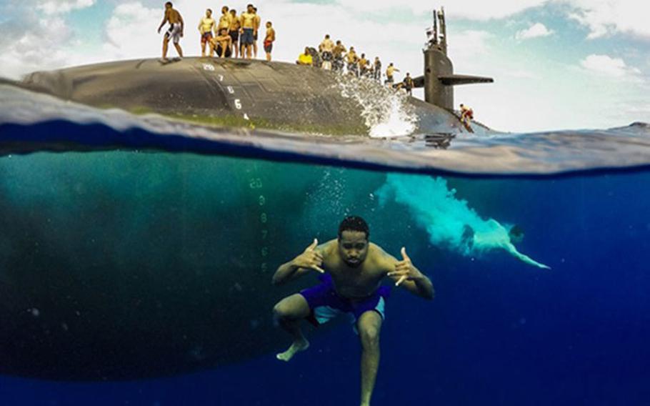 Sailors assigned to the Los Angeles-class fast-attack submarine USS Olympia (SSN 717) participate in a swim call in the Pacific Ocean, July 31, 2018 (Photo by: Navy Fire Control Technician Senior Chief Vien Nguyen).