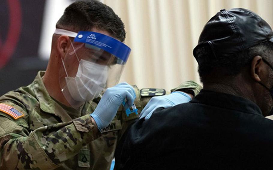 Army Pfc. Tanner Tate, a medic assigned to the 528th Field Hospital, vaccinates a community member at the state-run, federally-supported Elizabeth High School COVID-19 Community Vaccination Center in Elizabeth, New Jersey, March 5, 2021 (Photo by: Army Pfc. Jailene Bautista/5th Mobile Public Affairs Detachment).