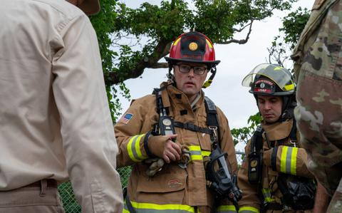 Photo Of Staff Sgt. Patrick Walsh and Senior Airman Edward Abisada talk with participants in the annual spill response exercise.