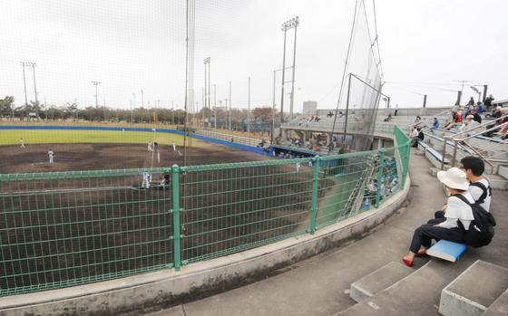 spectators are watching baseball game.