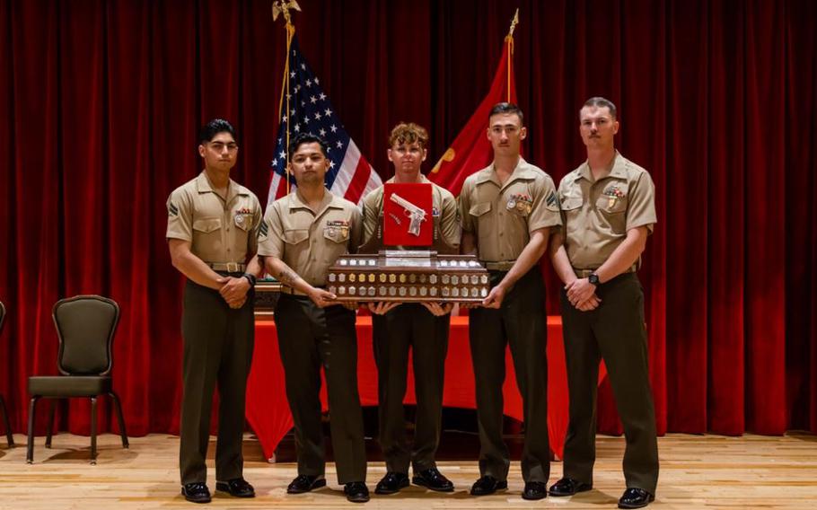 U.S. Marines with 9th Engineer Support Battalion (ESB), 3rd Marine Logistics Group (MLG), pose for a photograph with the Shively Trophy after an awards ceremony on Camp Hansen, Okinawa, Japan, Dec. 15, 2023. The team was awarded the Shively Trophy for taking first place during the Marine Corps Marksmanship Competition Far East.