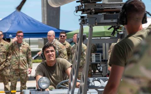 Photo Of U.S. Air Force Airman 1st Class Jordyn Heard transports and attaches inert munitions.