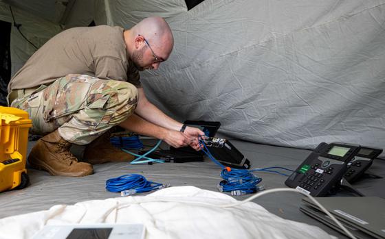 Photo Of U.S. Air Force Airman 1st Class Cody McGuire, 18th Communications Squadrons enterprise technician, uses a fly away kit to set up phone lines during an agile combat employment exercise, Shogun Shield, at Kadena Air Base, Japan, Sept. 18, 2024. The fly away kit is capable of generating secure lines of communication in austere locations which is necessary to call for supplies and receive instructions and information from Wing leadership. 