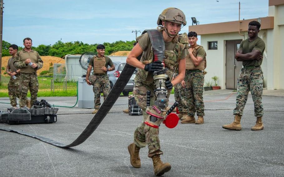 U.S. Air National Guard Staff Sgt. Sterling Morgan, 134th Logistics Readiness Squadron, pulls a fuel hose.