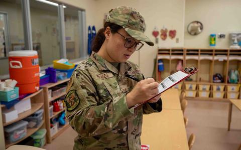 Photo Of Senior Airman Reina Morales fills out the quality control sheet.