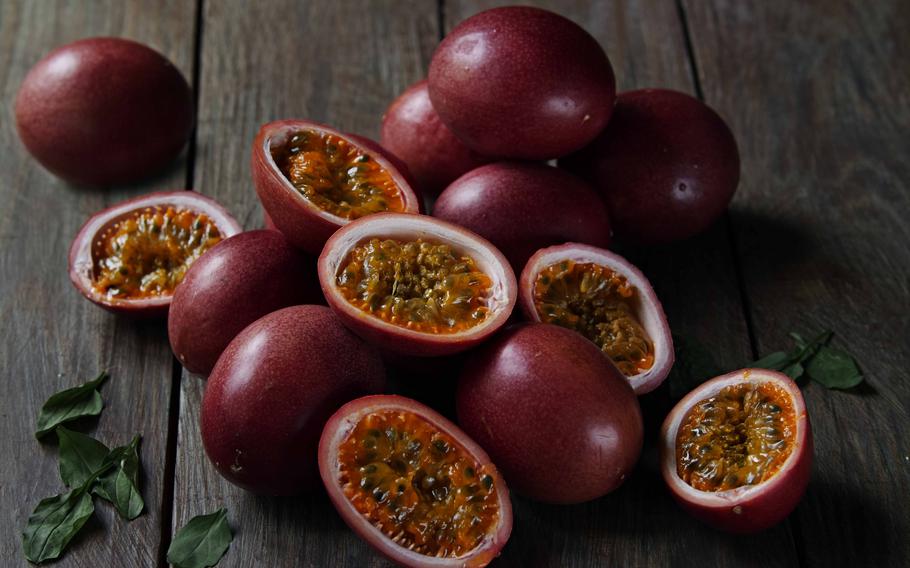 Passion fruits. Some of them are cut in half.