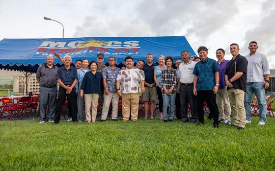 U.S. Marines with 4th Marine Regiment, 3d Marine Division, Marine Corps Installations Pacific, and officials of the local Henoko government pose for a group photo.