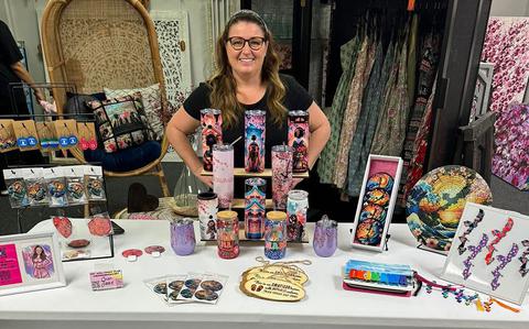 Photo Of Jessica Lewis poses in front of the table.