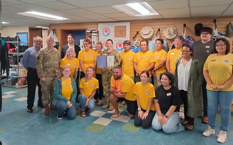 Photo Of Kadena Marina staff members pose with Stars and Stripes Pacific staff.