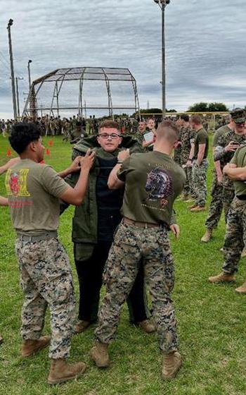 Members of the 12th Littoral Logistics Battalion gear up in full Explosive Ordnance Disposal suits, ready to take on a high-intensity challenge that tests their strength, endurance, and resilience.