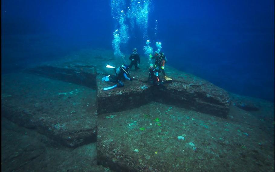 four divers are on the rock.