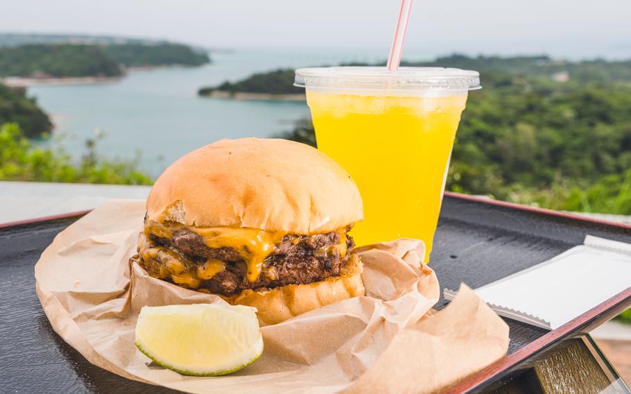 hamberger, french fries, and a soft drink on the table.
