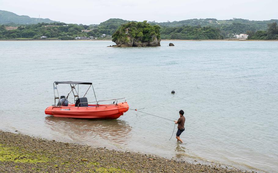 a man pulling a boat.