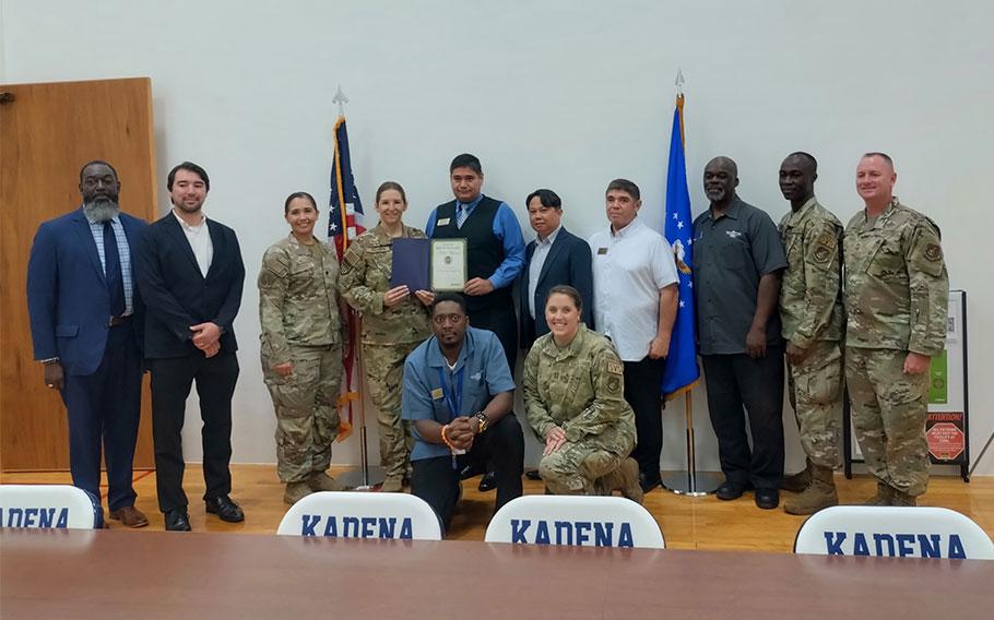 Kadena Shogun inn group photo as Stars and Stripes Commander Lt. Col. Marci Hoffman and SSP staff Kajito Tanaka present best on-base lodging award to Kadena Shogun inn staff.