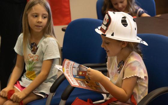 Photo Of Children of Status of Forces Agreement members read a coloring book during a fire and life safety class on Camp Foster, Okinawa, Japan, Sept. 13, 2024. MCIPAC F&ES hosted the class to teach home-schooled children various life safety skills in efforts to better prepare them in emergency situations. 